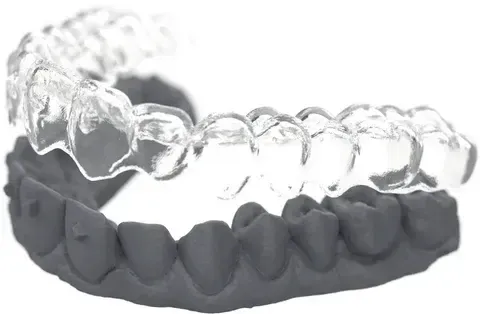 Thermoformed Essix retainer seated on the finished-arch model